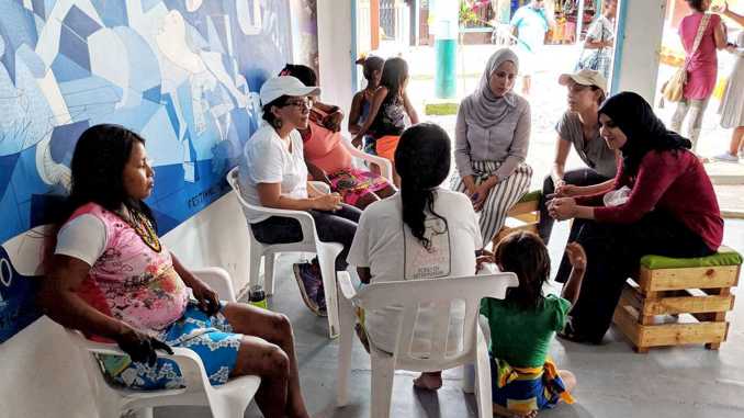 Aziza (right) speaking to indigenous women in Nuqui, Columbia