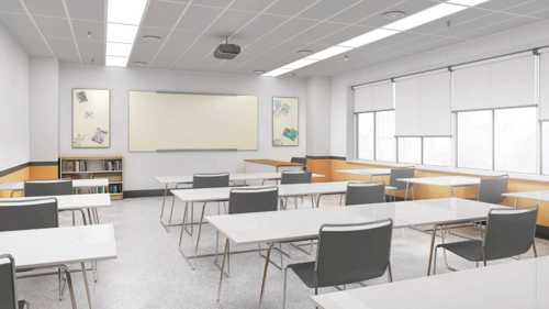 A photograph showing an empty classroom, rows of desks and chairs face towards a wall on which there is a whiteboard, from the ceiling hangs a projector and fluorescent strip lighting is recessed in the ceiling tiles